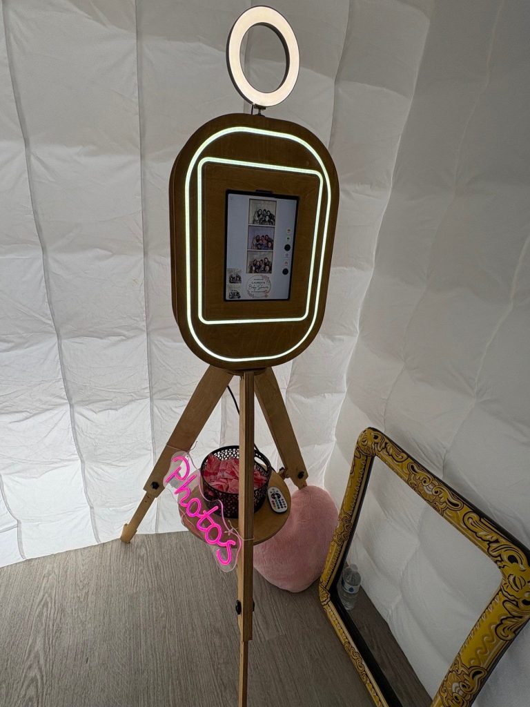 photo booth rental A decorative photo booth with a ring light and tripod stand.